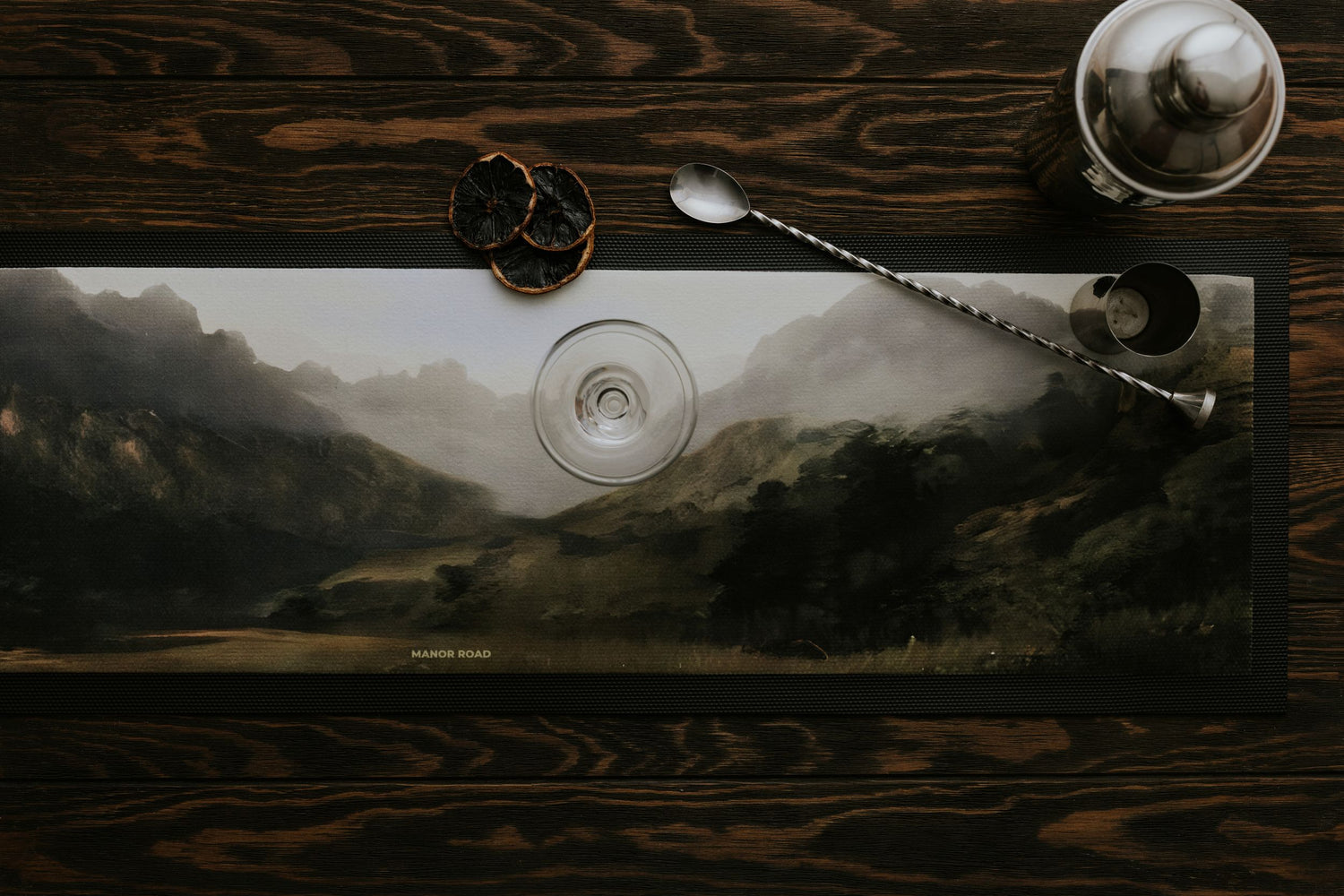 Large rubber backed bar mat by Manor Road with a landscape mountain image. With cocktail shaker and stirrer. 