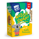 A boxed children's card game called 'Aussie Snap!' shown on a clean white background. The box is bright yellow, green, and blue with cartoon illustrations of a koala, kangaroo, and hedgehog, plus text including 'Ages 4+' and 'Made for little learners.