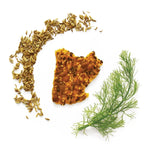 Fennel seeds, a piece of fennel bulb, and a sprig of dill on a white background