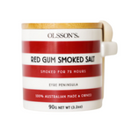 Olsson's Red Gum Smoked Salt in a white ceramic mug with red stripes, a light wood lid, and a cream-colored handle, shown on a white background.